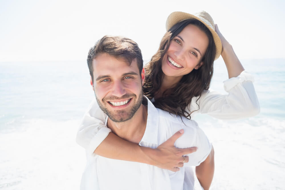 young attractive couple at a flordia beach after dental work