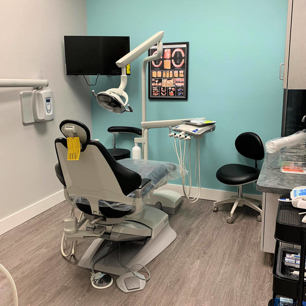 interior of dental practice with dental chair and equipment